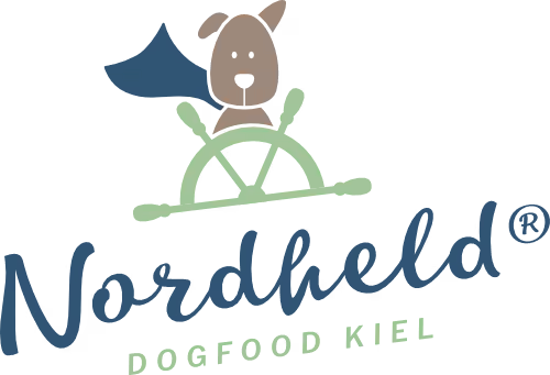 Illustration of a dog holding a steering wheel above the text Nordheld Dogfood Kiel.